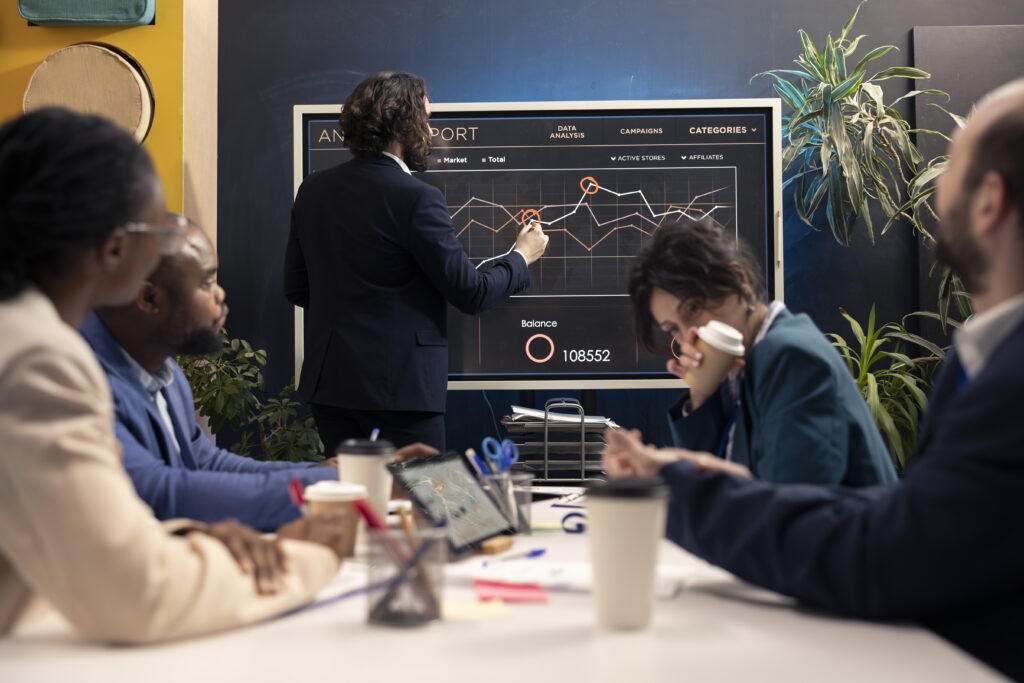 Diverse business team analyzing AI-powered data dashboard representing digital growth and data-driven success