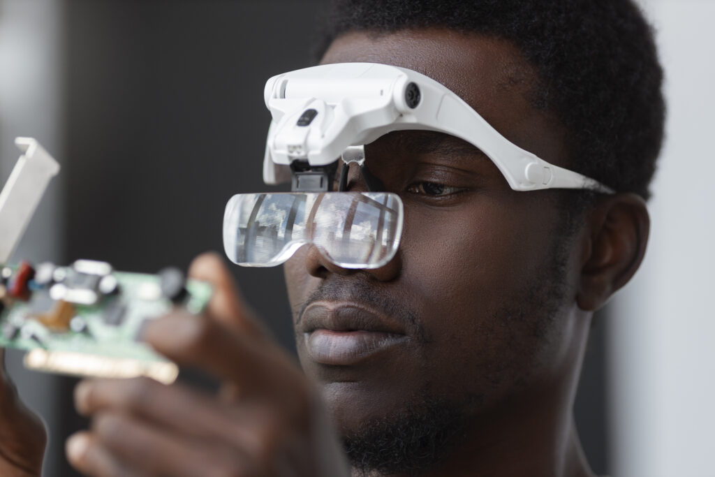 Computer vision system inspecting products on a production line with AI detecting defects using bounding boxes and pass/fail indicators.